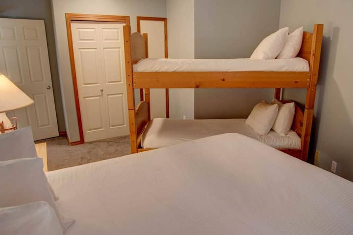 The second bedroom contains bunk beds and a queen bed.