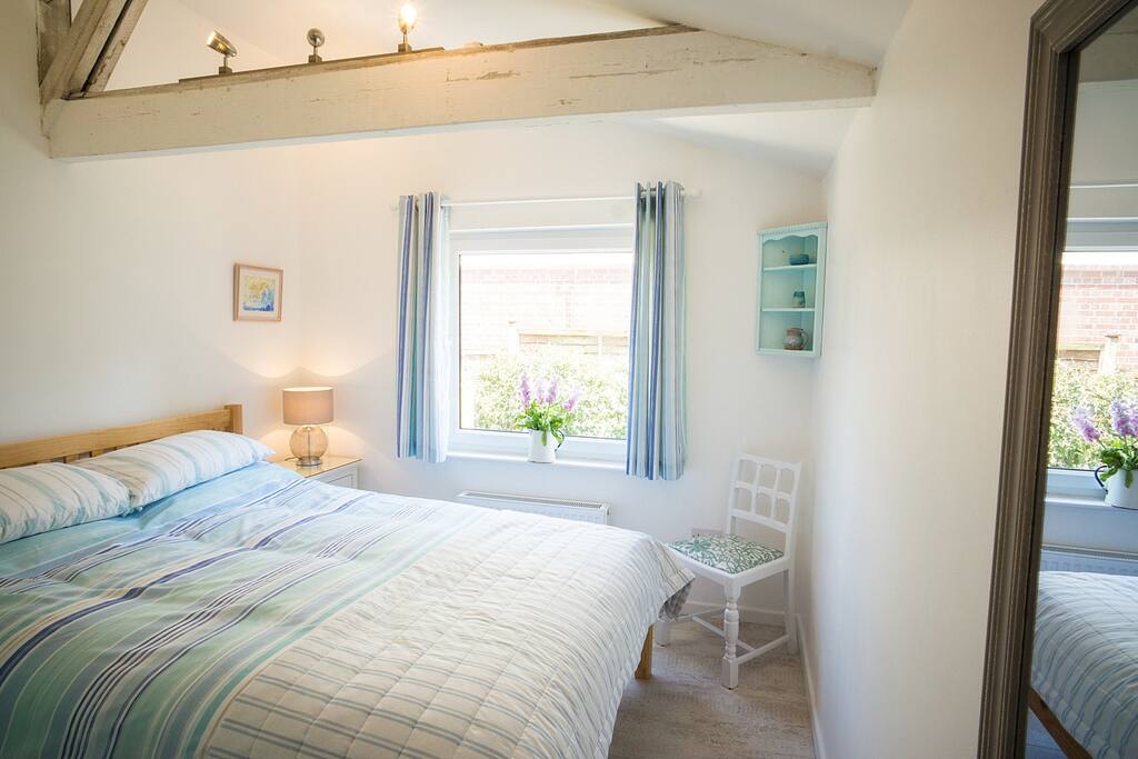 Master bedroom with wardrobe and tallboy.