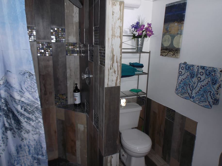 Rustic style bathroom with "wooden" shower- just like one in Flip or Flop! Huge shower head! Sink with touchless faucet!