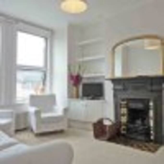 Living room with working fireplace. We now have a nice grey double sofa (not the white ones as per pic).