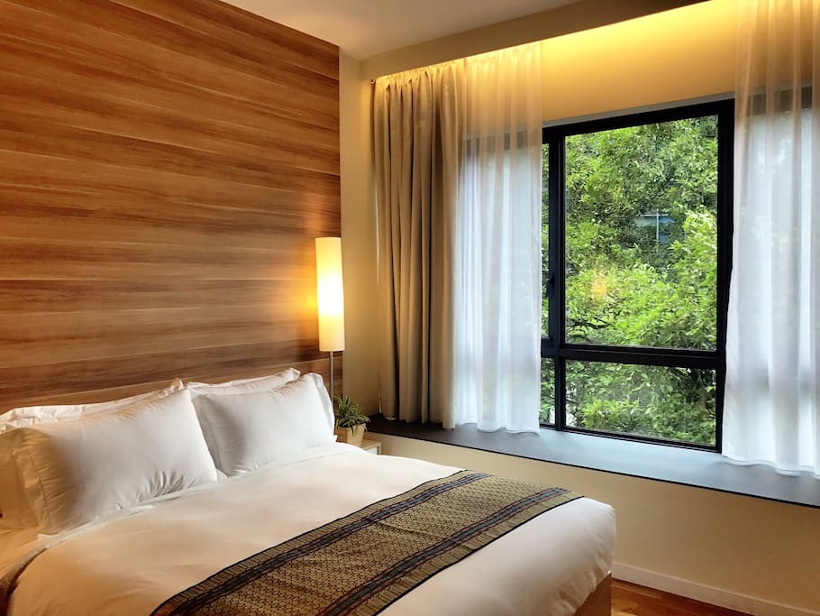 The Queen Room (private) with huge bay window overlooking green sanctuary.