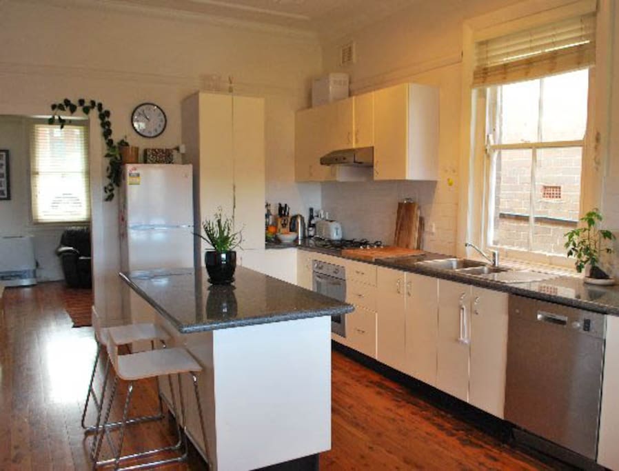 Open plan kitchen with gas and dishwasher.