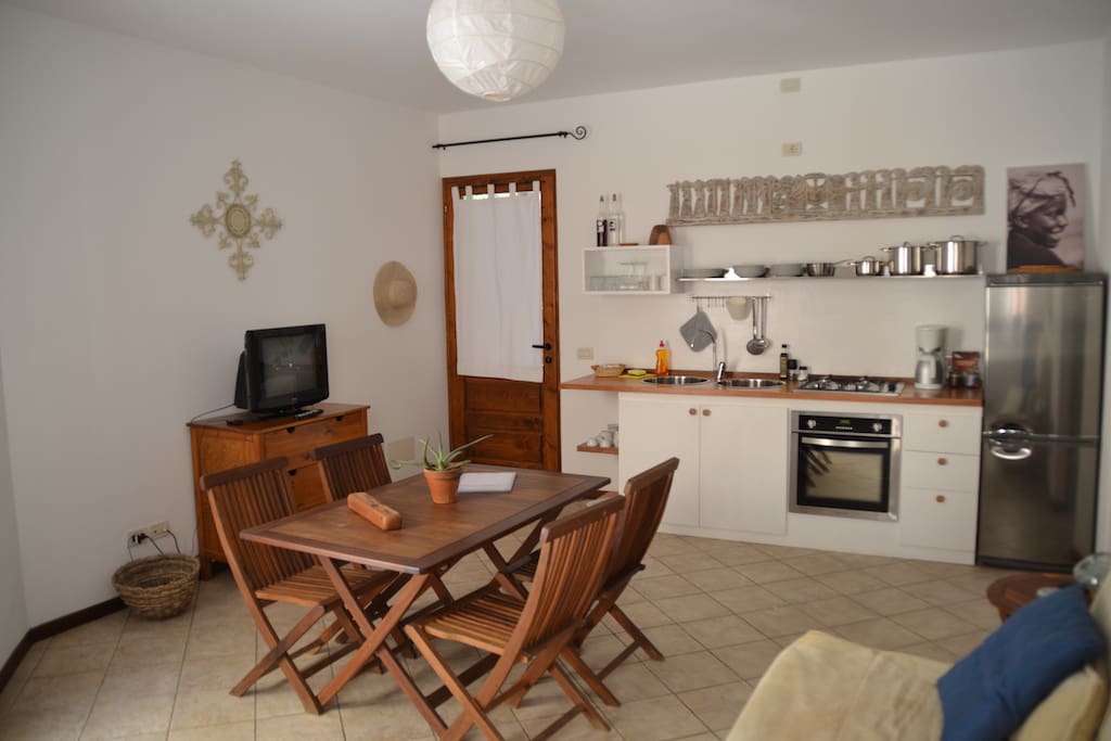 Living room with fully equipment kitchen.