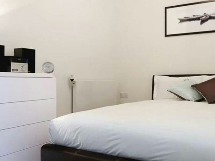 Large double bed in bedroom enclosure with plenty of storage space
