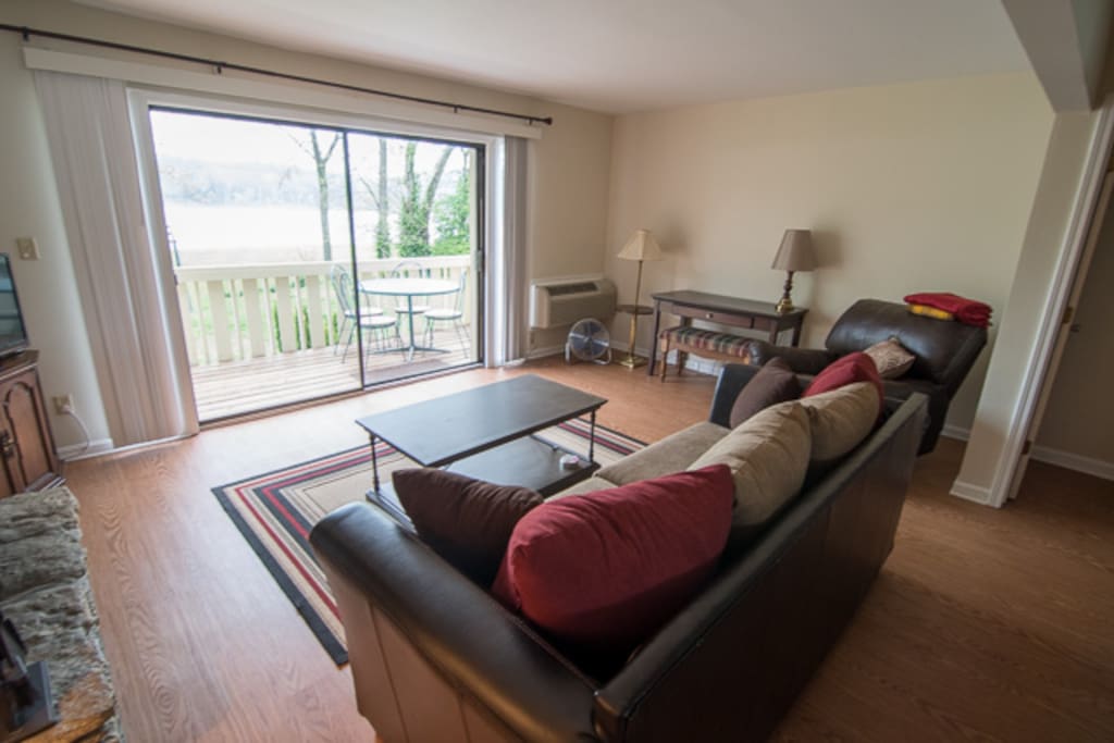 Spacious living room facing out onto The Ohio River and Charlestown State Park. Simply step out on to the balcony to enjoy the view including the stunning sunsets.