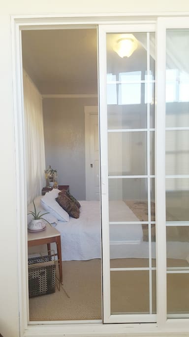 The front door leads you to an enclosed porch with a sliding glass door that enters your private bedroom