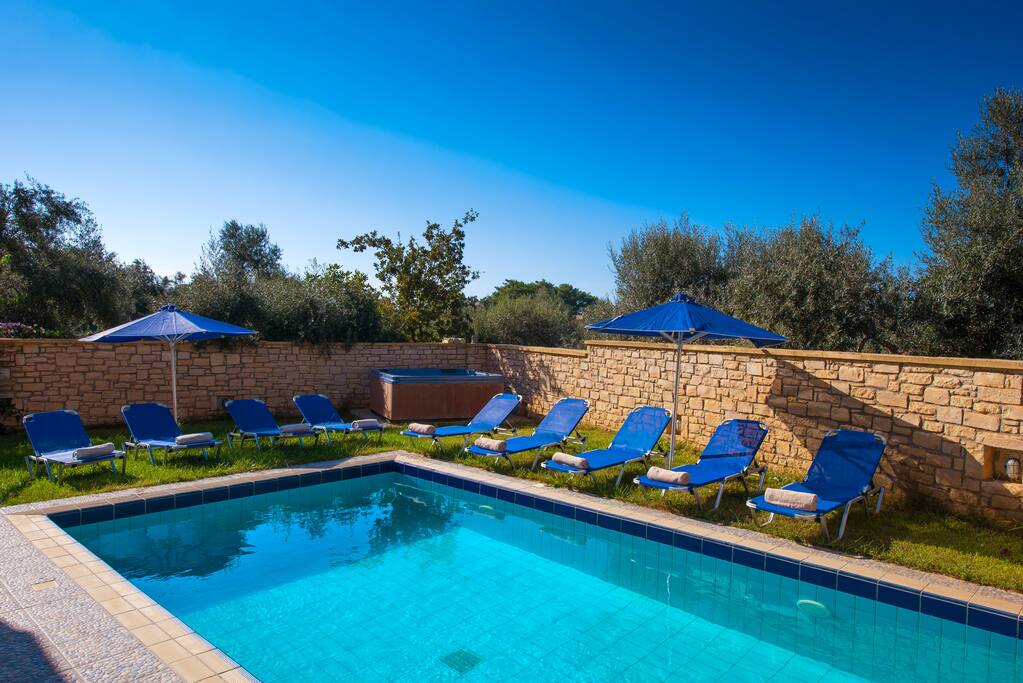 Pool area with 12 sun beds and umbrellas
