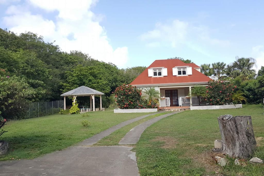 The property has a wide garden space and a cozy gazebo.