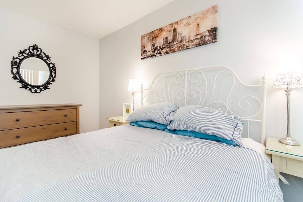 Bedroom with queen size bed next to the washroom.