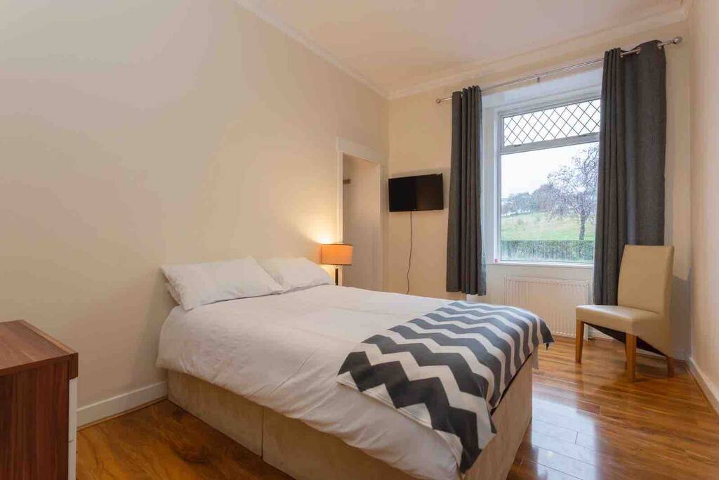 Bedroom with double bed and TV