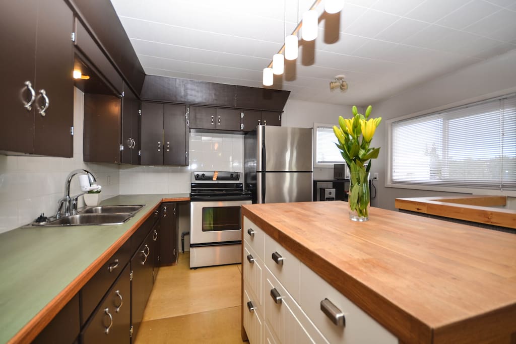 Kitchen and Island with Fridge, Stove & Sink