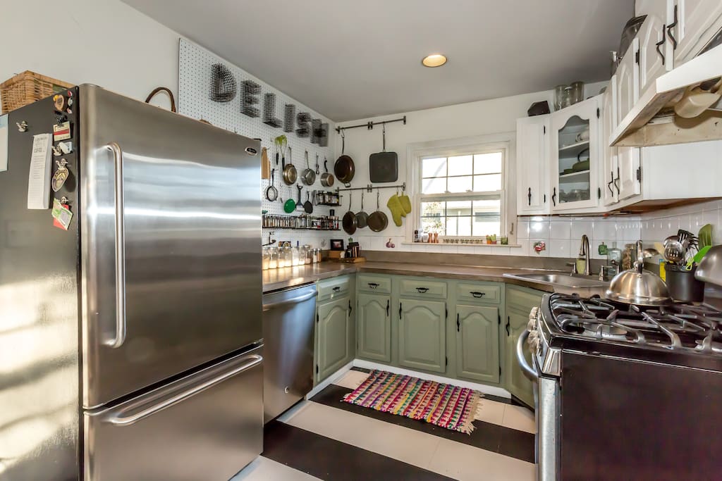 Kitchen is fully stocked with a full fridge, dishwasher, gas range, microwave and toaster.