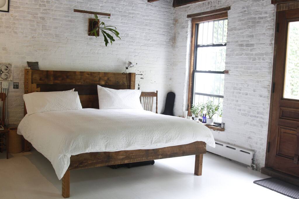 spacious bedroom with custom made king size bed and all natural organic mattress.