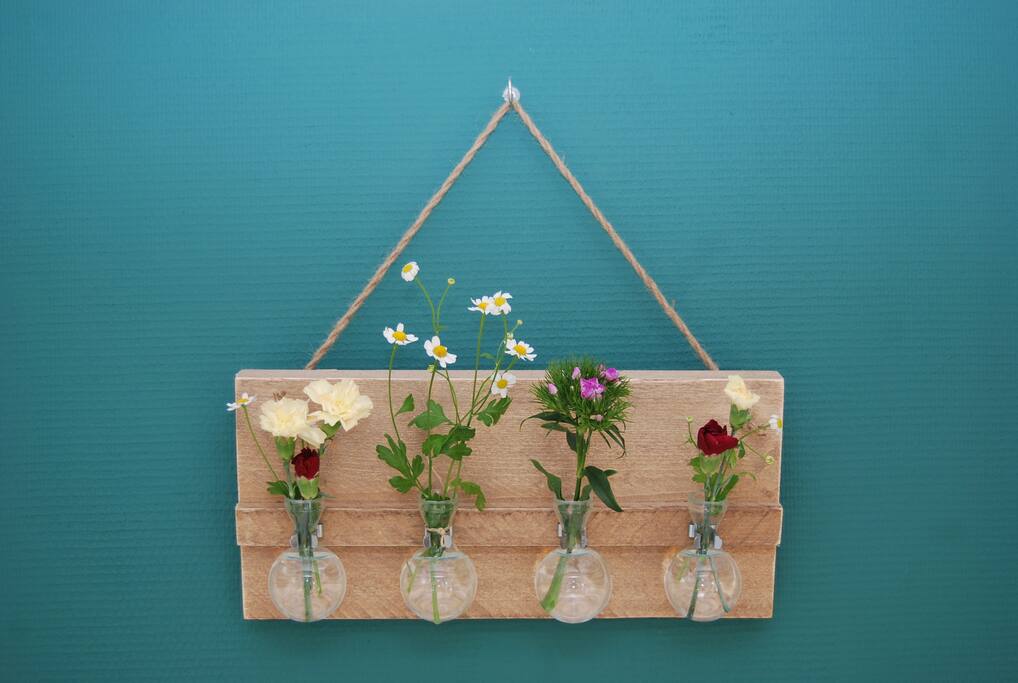 Fresh flowers from the market on the wall.