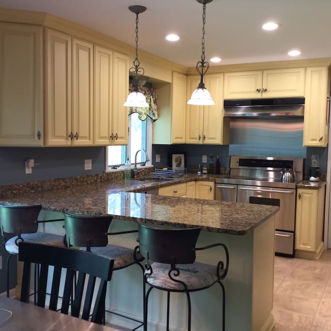 Kitchen with 3 bar seats plus eat-in kitchen. Fully stocked kitchen supplies.