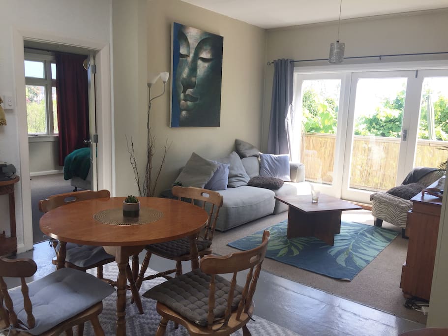 Warm open plan living area with double french doors opening out on to a intermit little deck with a view over the port to the infinite ocean.