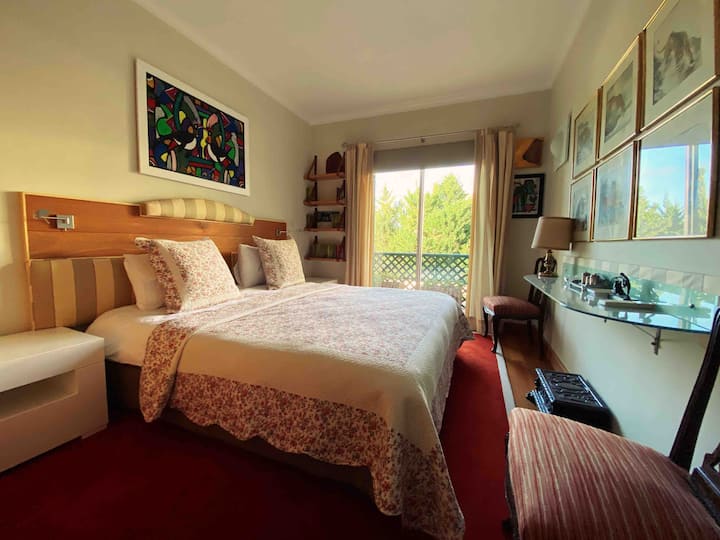 Bedroom 2 with balcony overlooking pool