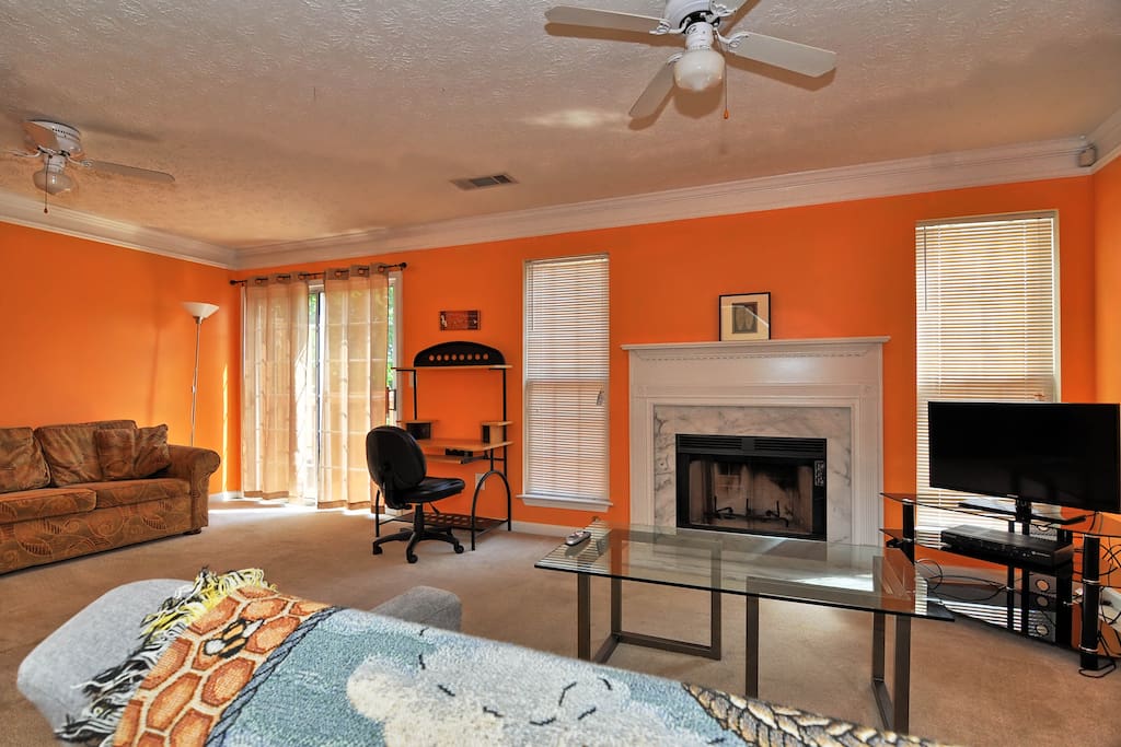 Living room with fireplace and access to the deck and back yard. Home is equipped with COMCAST TV and WIFI