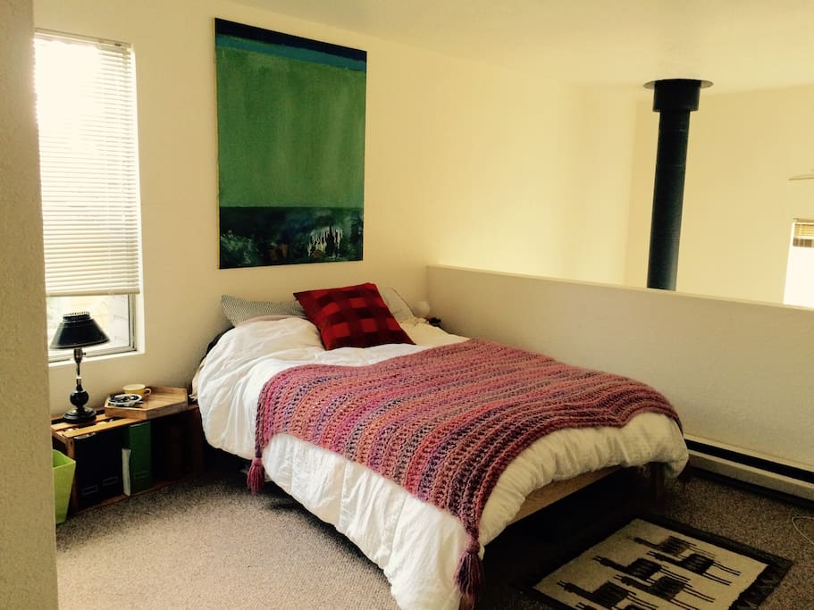 The queen bed is located upstairs with the bathroom
