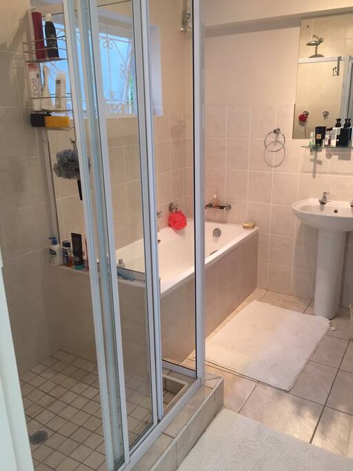 Bathroom with bath tub and shower as well as 2 x separate toilets, one downstairs and one up stairs