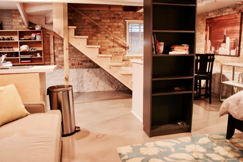 Open floor plan with plenty of storage space under stairs