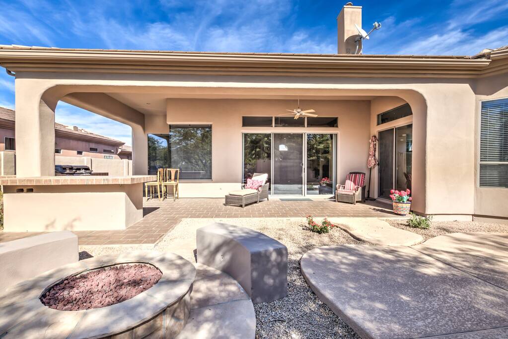 Backyard area with BBQ grill, fireplace, private pool and sitting area.
