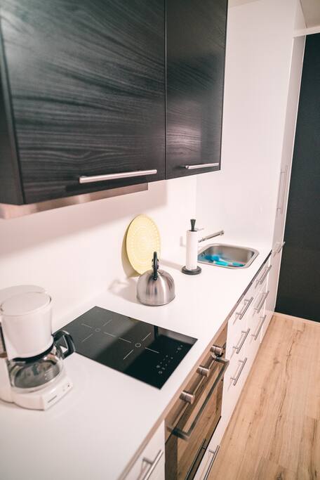 In the kitchen among other things is a dishwasher, toaster and a coffeemachine.