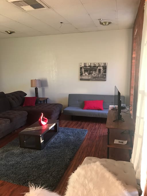 Living room area with futon that opens up into another bed..