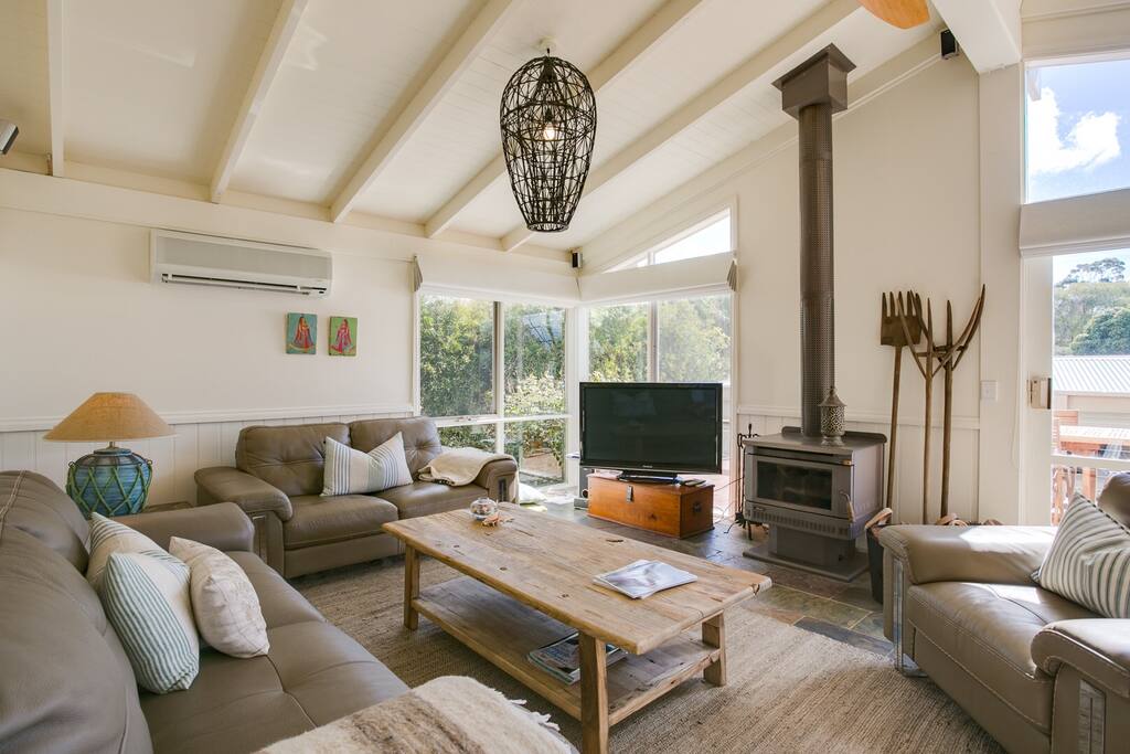 Spacious living room with wood fire.