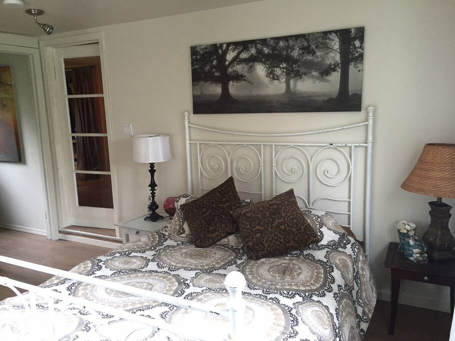 Our guests love this queen size bed with a view out to the trees.