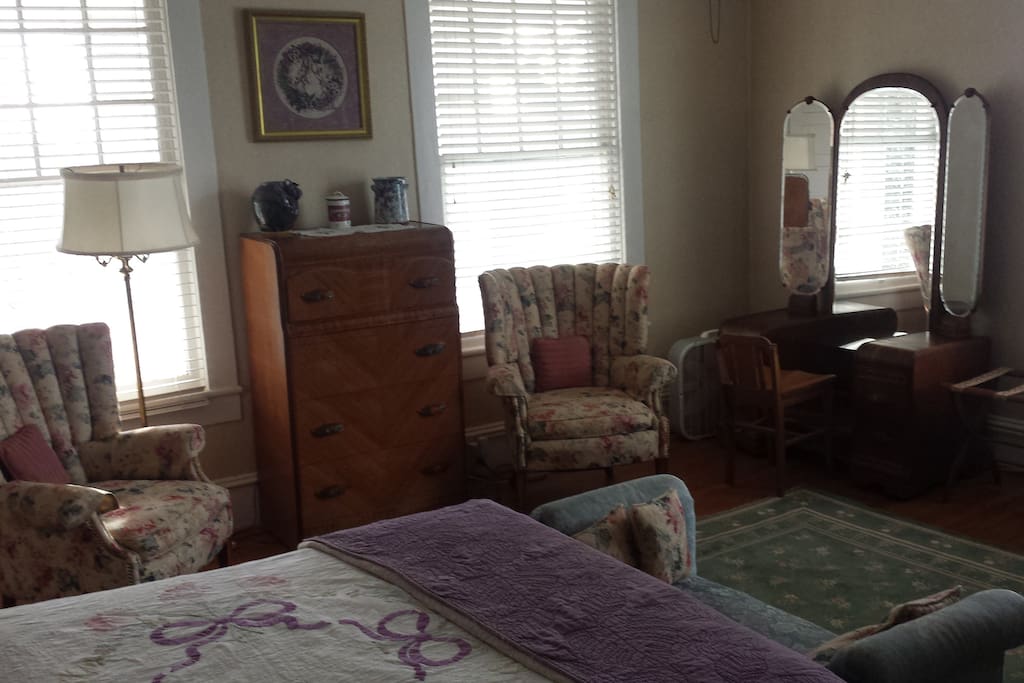 Waterfall chest and dresser flanked by matching wing back chairs