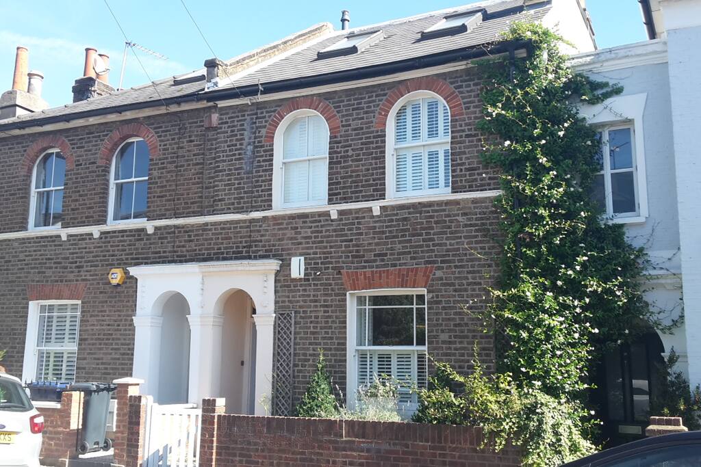 Front of House with pretty landscaped traditional English planting