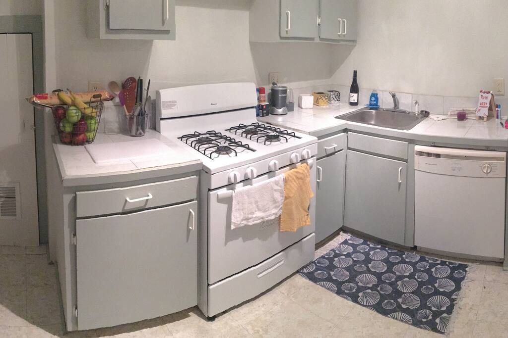 Kitchen includes dishwasher, fire based stove top, oven, and sink along with all necessary utensils.