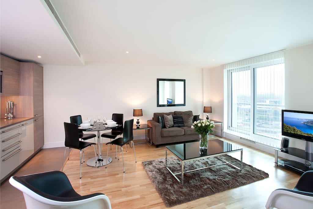Comfortable Living-room with flat-screen TV and a work/dining table