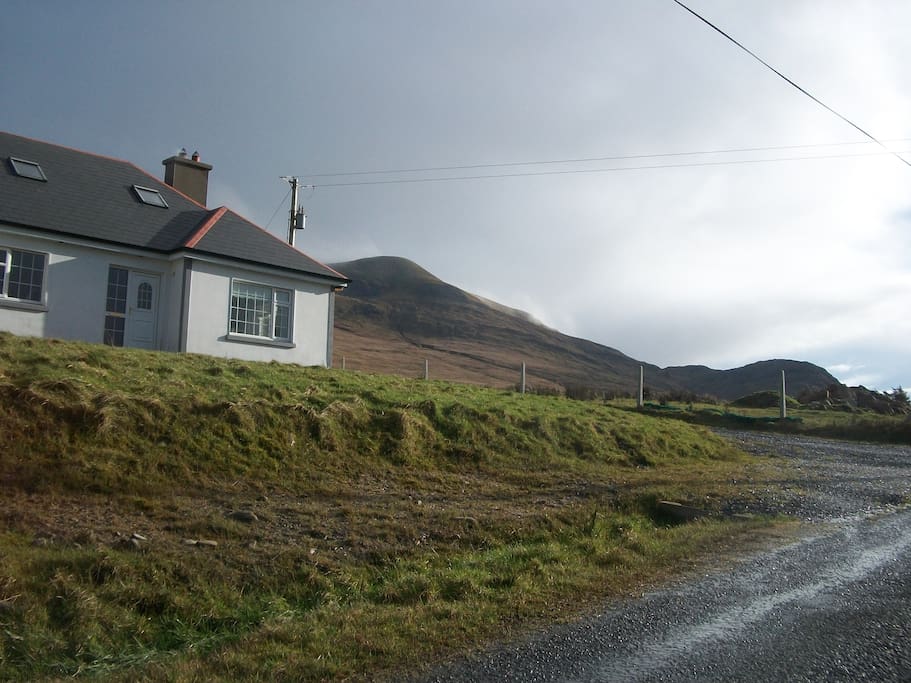 House from road showing Mweelrea mountain, (popular with climbers).