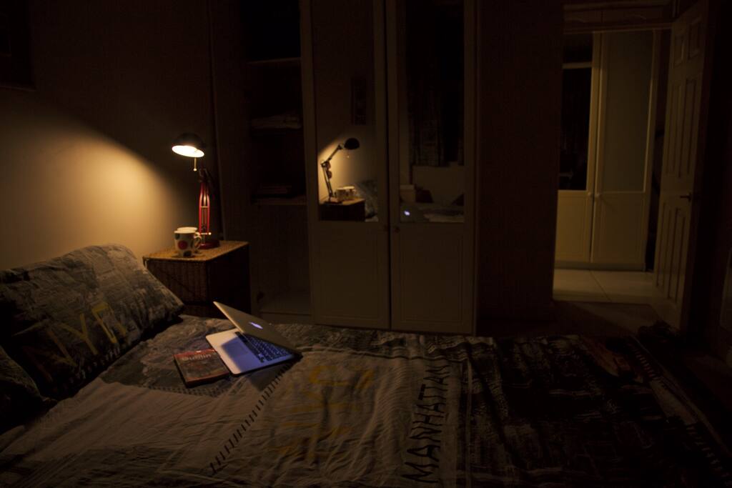 Spacious bedroom with a bathroom next to it.