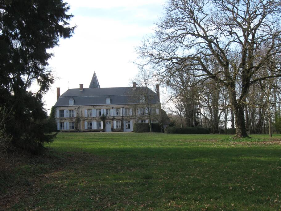 Surrounded by dozens of mature trees and lawns and meadows
