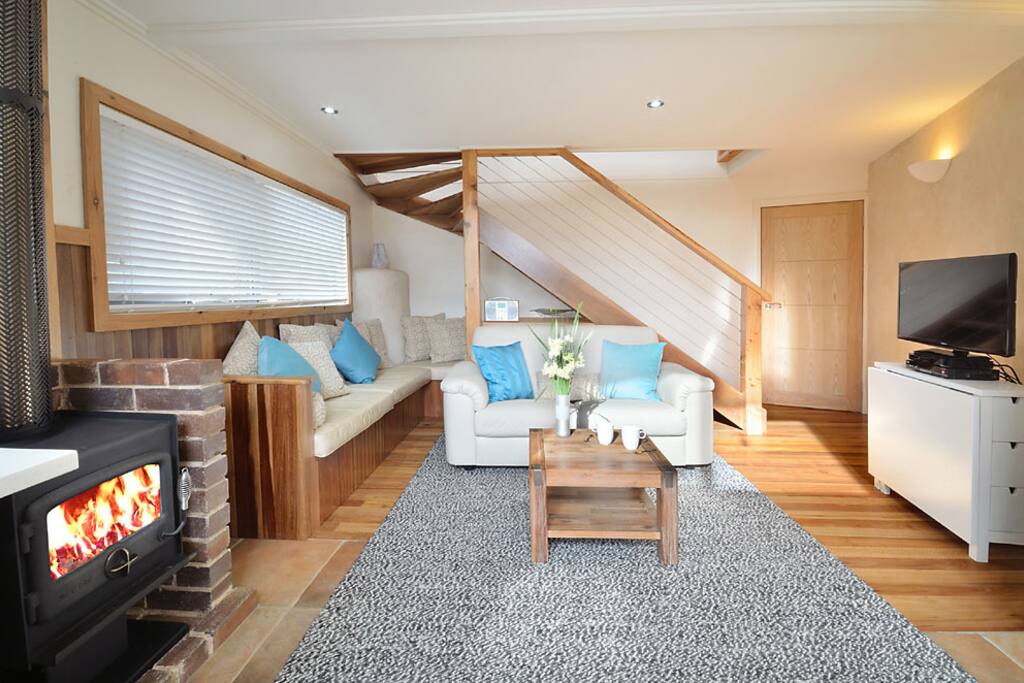 cosy lounge area with wood fired combustion stove, gas heater, TV/DVD/Blue ray, digital radio with ipod docking