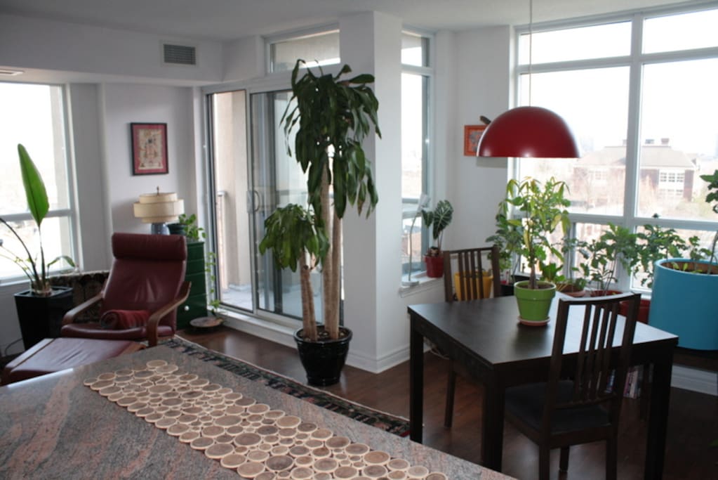 Open concept common spaces as viewed from kitchen counter toward southeast corner and balcony.