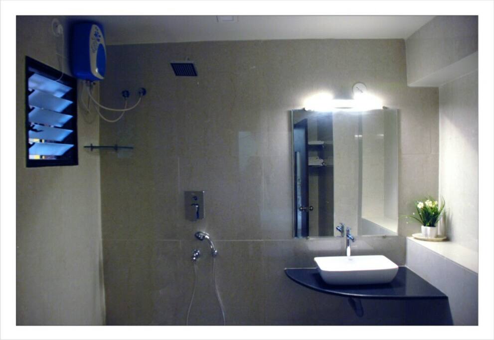 A Big Bathroom with high class fittings .