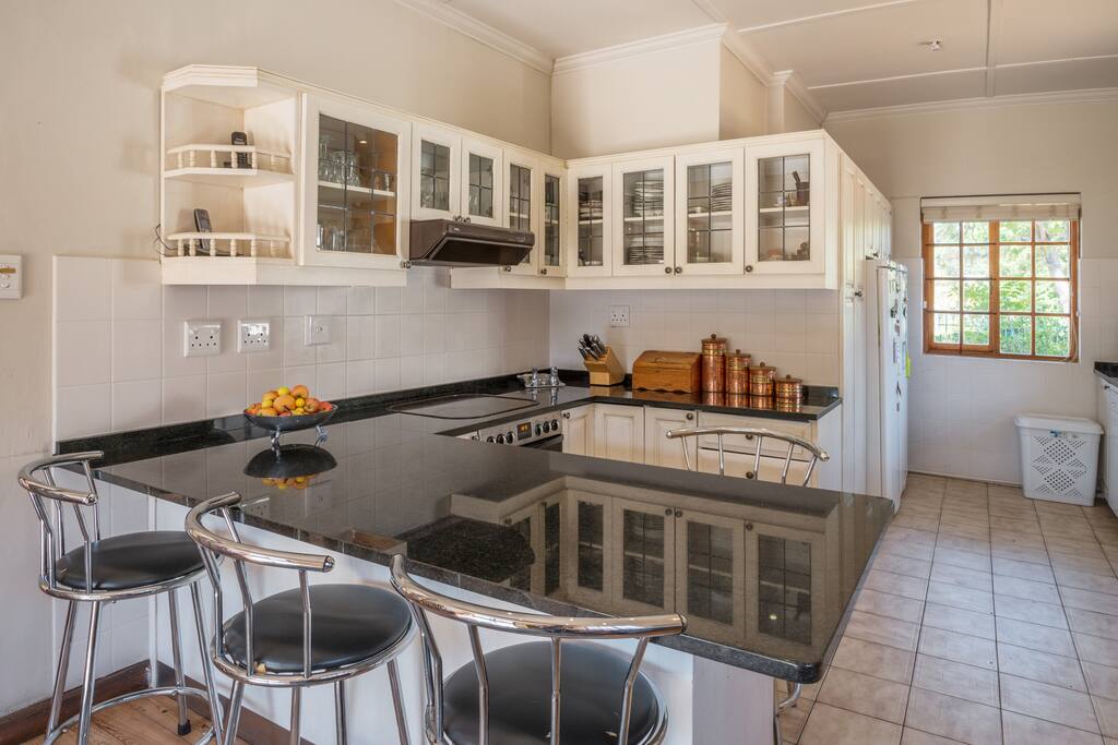 Modern kitchen with french doors opening out onto pool area