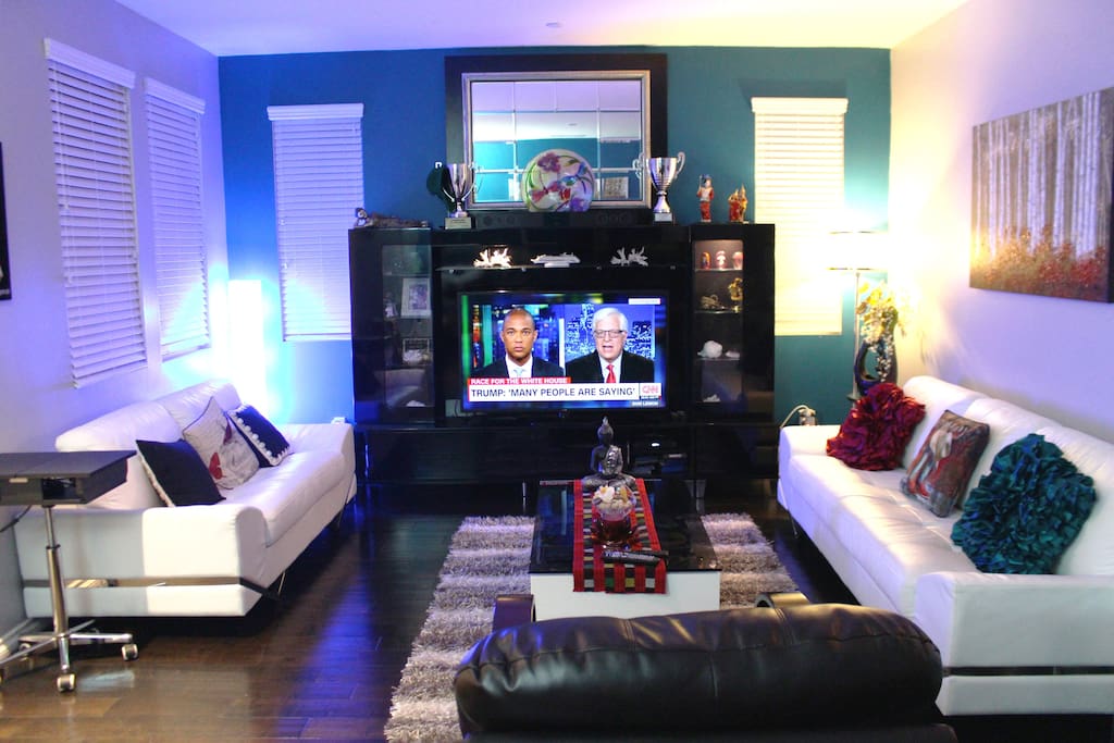 Spacious living room with modern TV and furniture