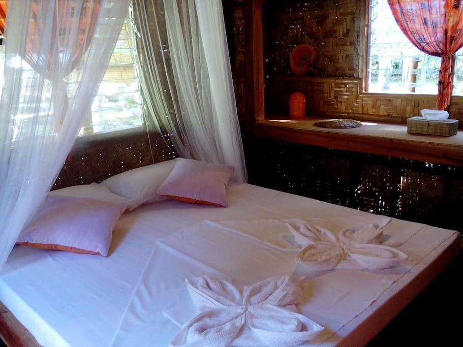 Bedroom of Orange bungalow with queen size bed