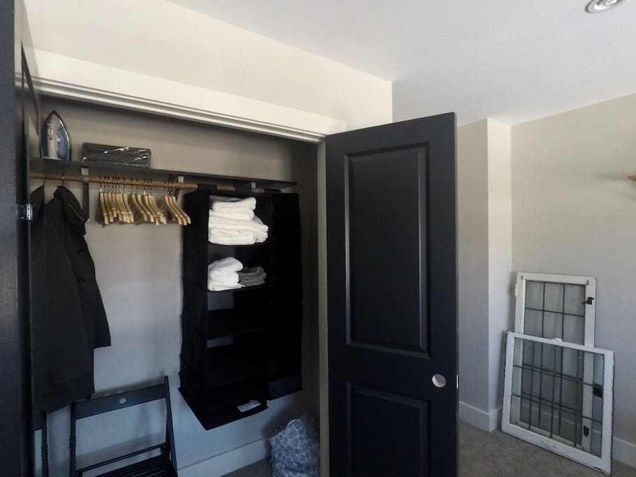 You'll find a lot in the spacious closet: extra chair, iron, hangers, laundry hamper, shelf space, clean towels & wash cloths.