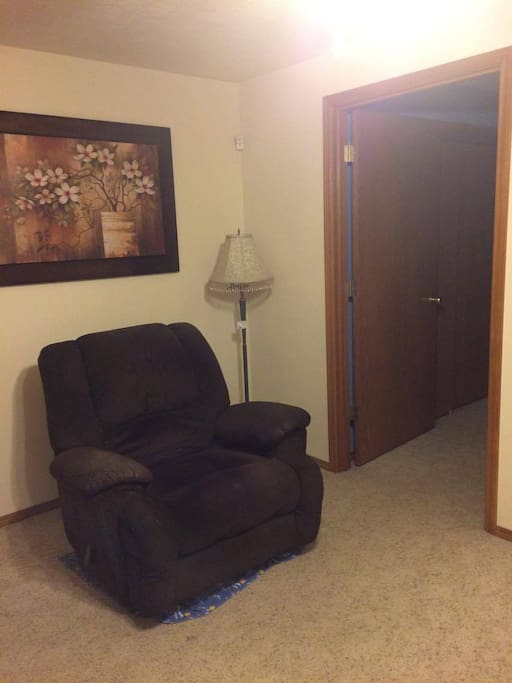 Recliner in living room area; bedroom entrance.