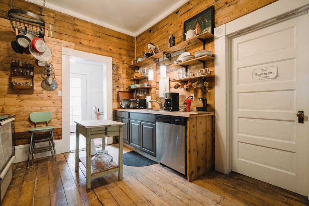 The guest kitchen is fully stocked with cookware and plate.