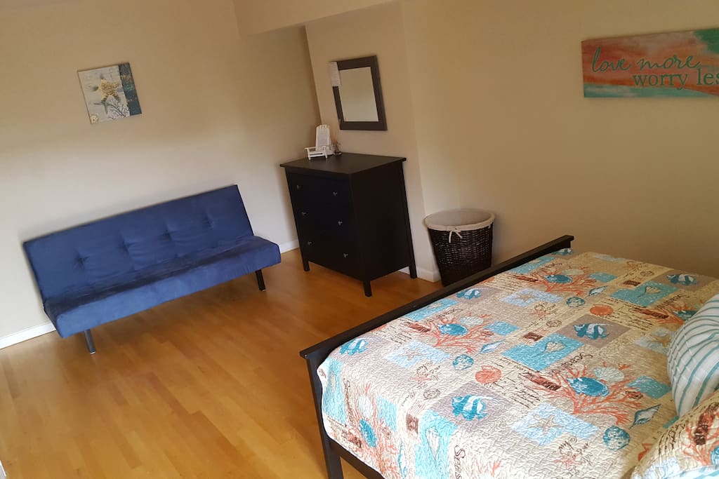 Bedroom with a small sofa and large closet