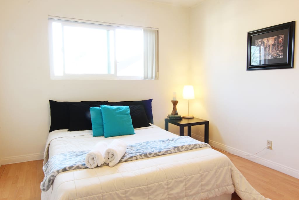 Spacious main bedroom with large super comfy tempurpedic style queen bed.