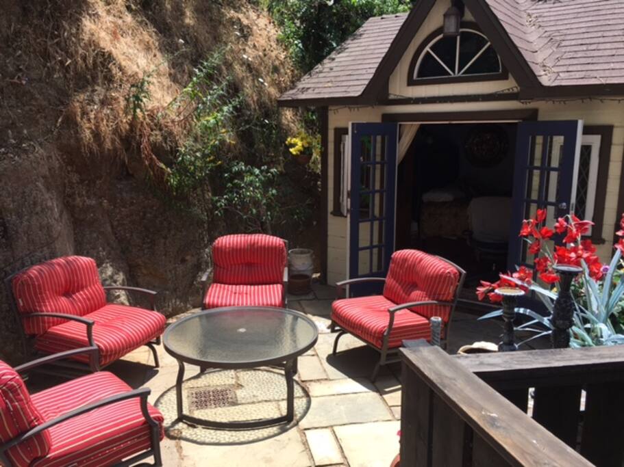 Guesthouse with outdoor seating area that connects to side entrance to house and private bathroom