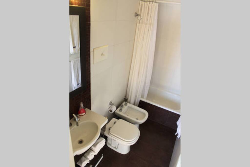 Modern tiled bathroom with full tub.
